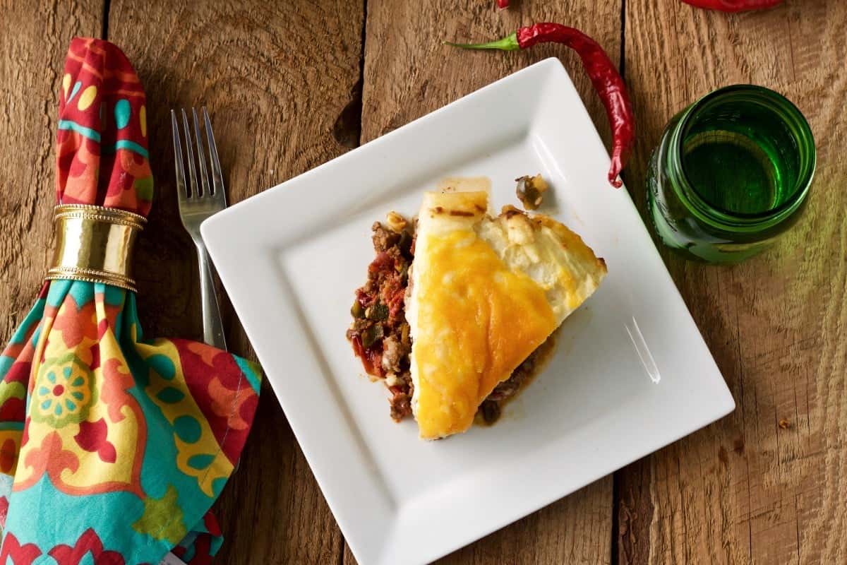 Shepherd's pie has a hamburger filling spiced with a southwestern flair, topped with creamy mashed potatoes and melted shredded cheese. A comforting, filling casserole. https://homemadefoodjunkie.1wp.site