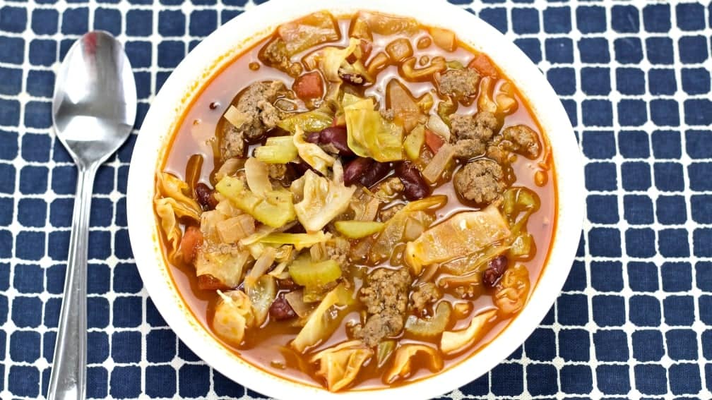 Cabbage Patch Soup in a white bowl on a blue plaid cloth