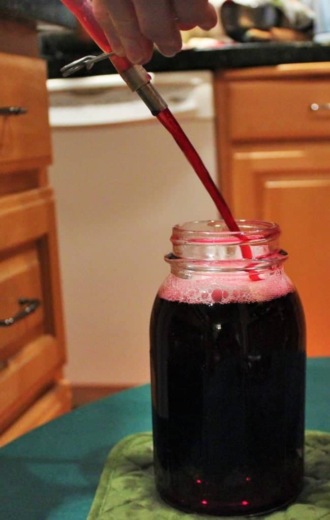 Filling a jar with grape juice