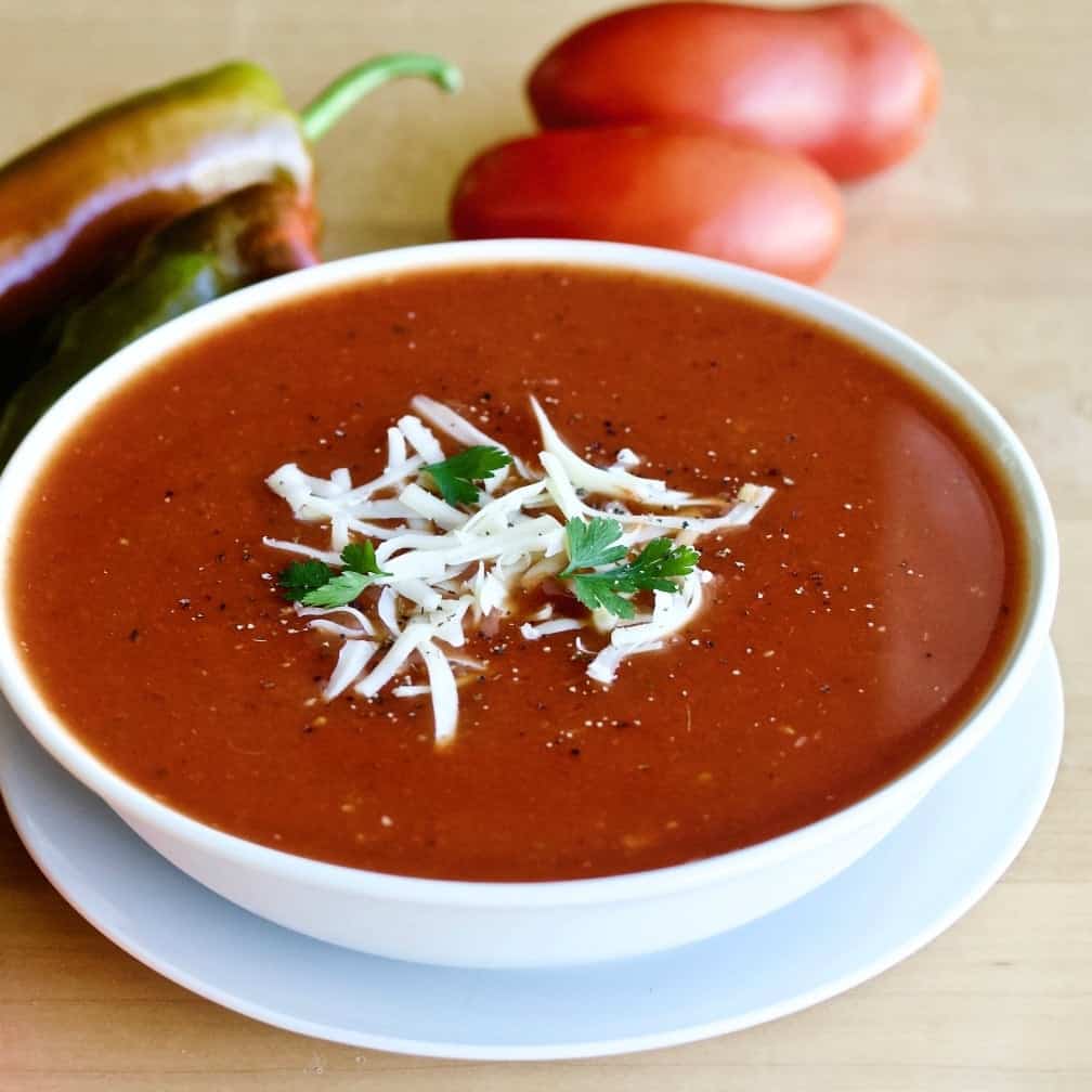 Roasted pepper tomato soup with our fresh peppers and tomatoes in background