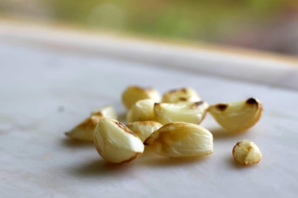 roasted garlic cloves on a white plate