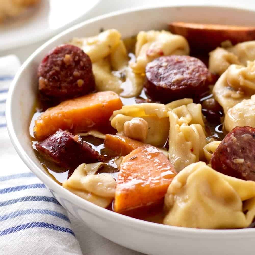 Crock pot tortellini sausage soup. delicious, high fiber soup https://homemadefoodjunkie.1wp.site