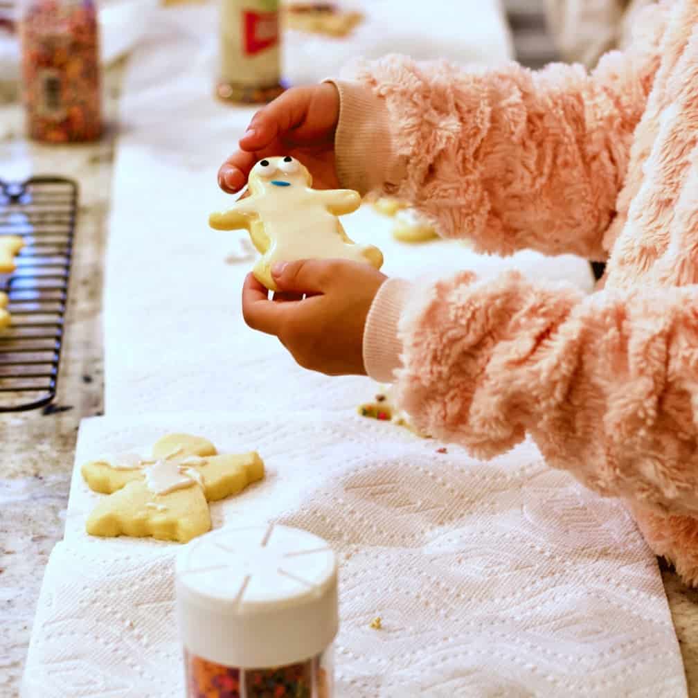 Child showing her decorated shortbread cookie