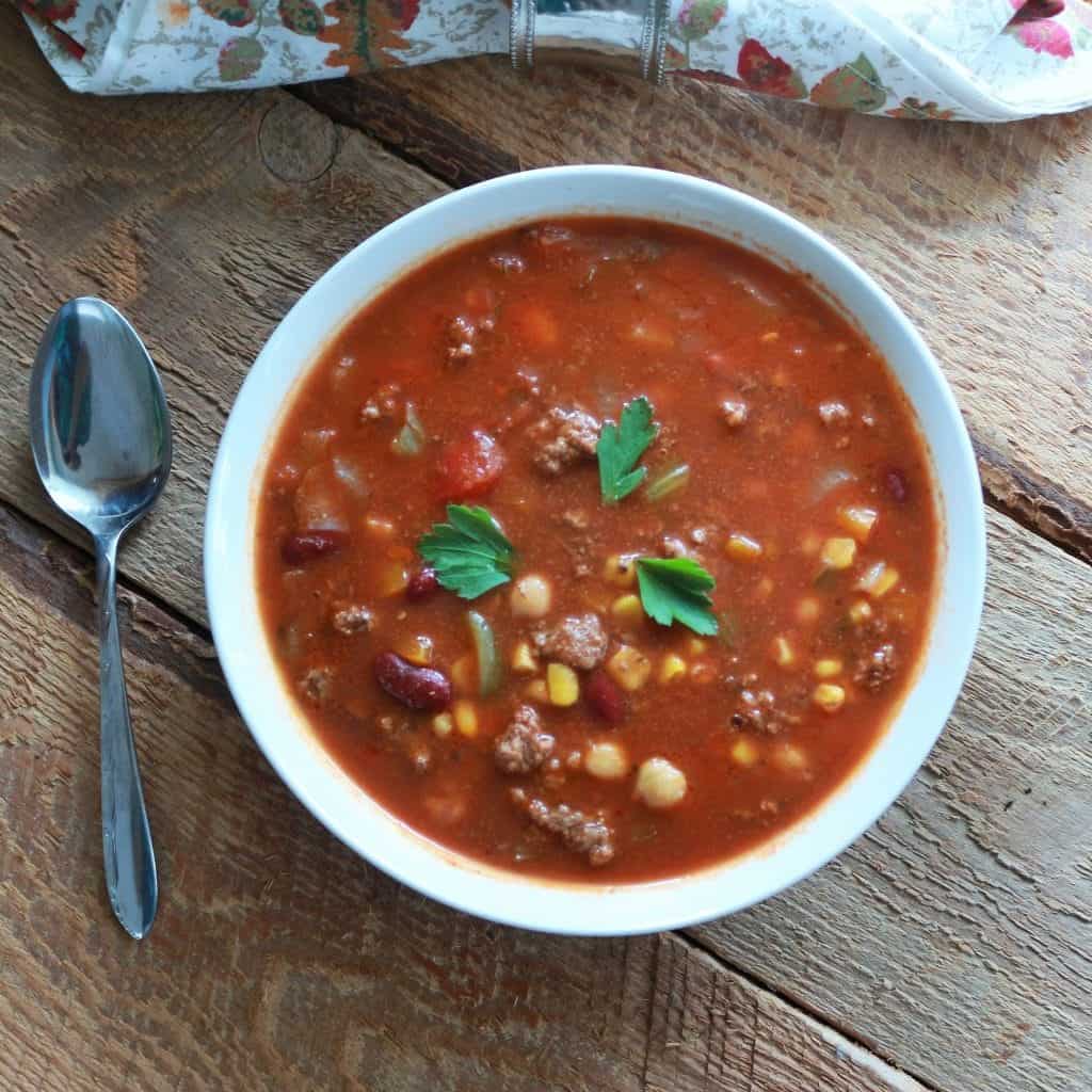 Crock Pot Taco soup full of Mexican spice, legumes, hamburger and veggies for a filling , healthy winter soup. https://homemadefoodjunkie.1wp.site