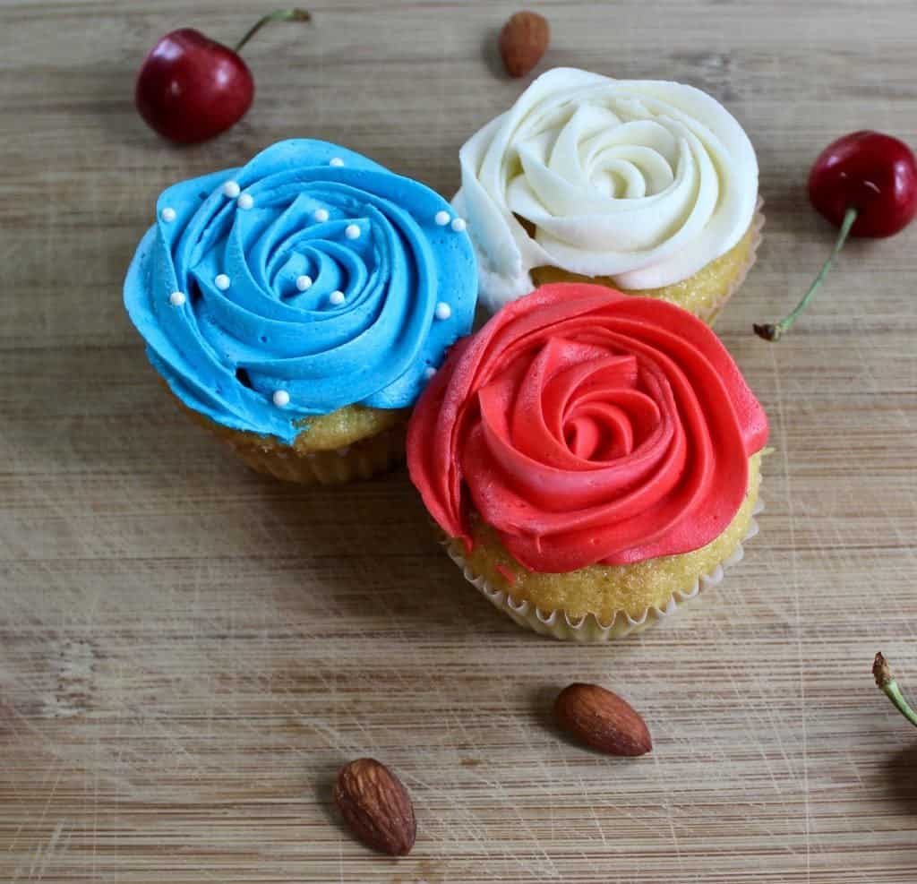 Festive Cherry Almond Cupcakes. A delicious almond cupcake topped with a silky cherry buttercream frosting!