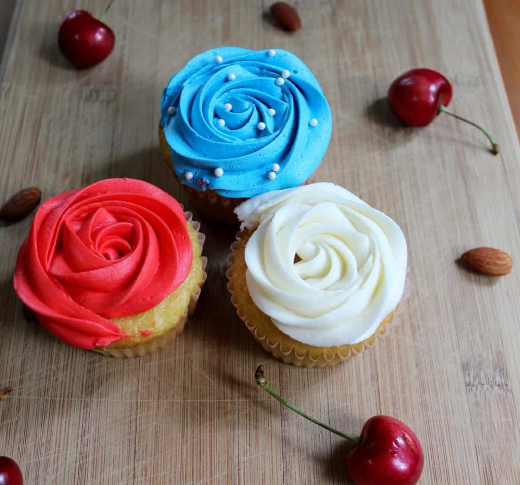 Festive Cherry Almond Cupcakes. A delicious almond cupcake topped with a silky cherry buttercream frosting!