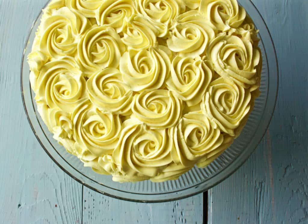 Lovely Lemon Cake as a round layer cake. With rose swirled yellow frosting.