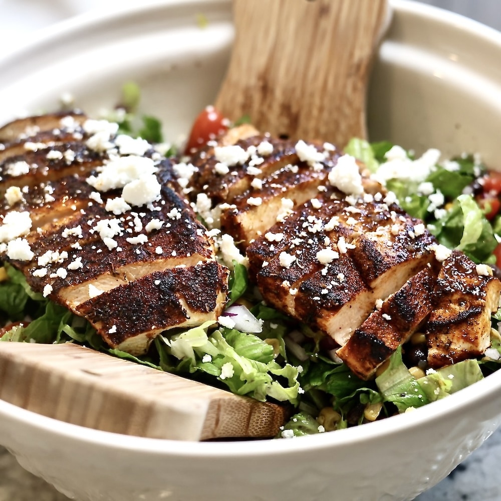 blackened chicken on salad with cheese