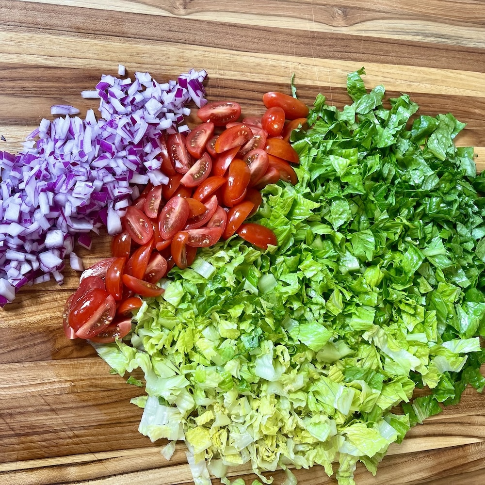 chopped lettuce, tomatoes and onions for blackened chicken salad