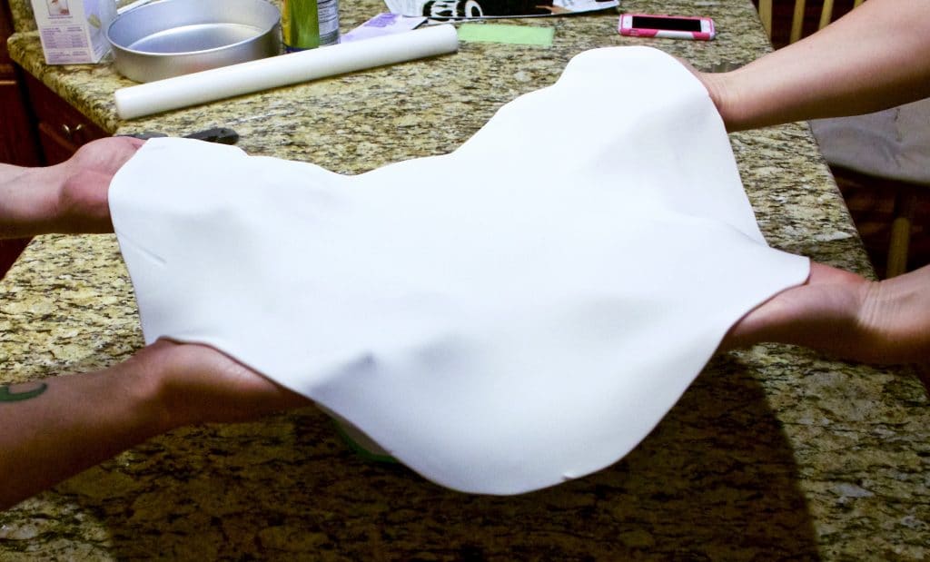 Lifting a sheet of white fondant