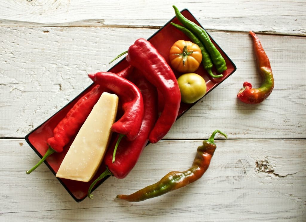 Use the best roasting peppers and a fresh block of real parmesan cheese for this recipe. Fresh peppers, tomatoes laying on a tray. For the parmesan for roasted peppers parmesan recipe.