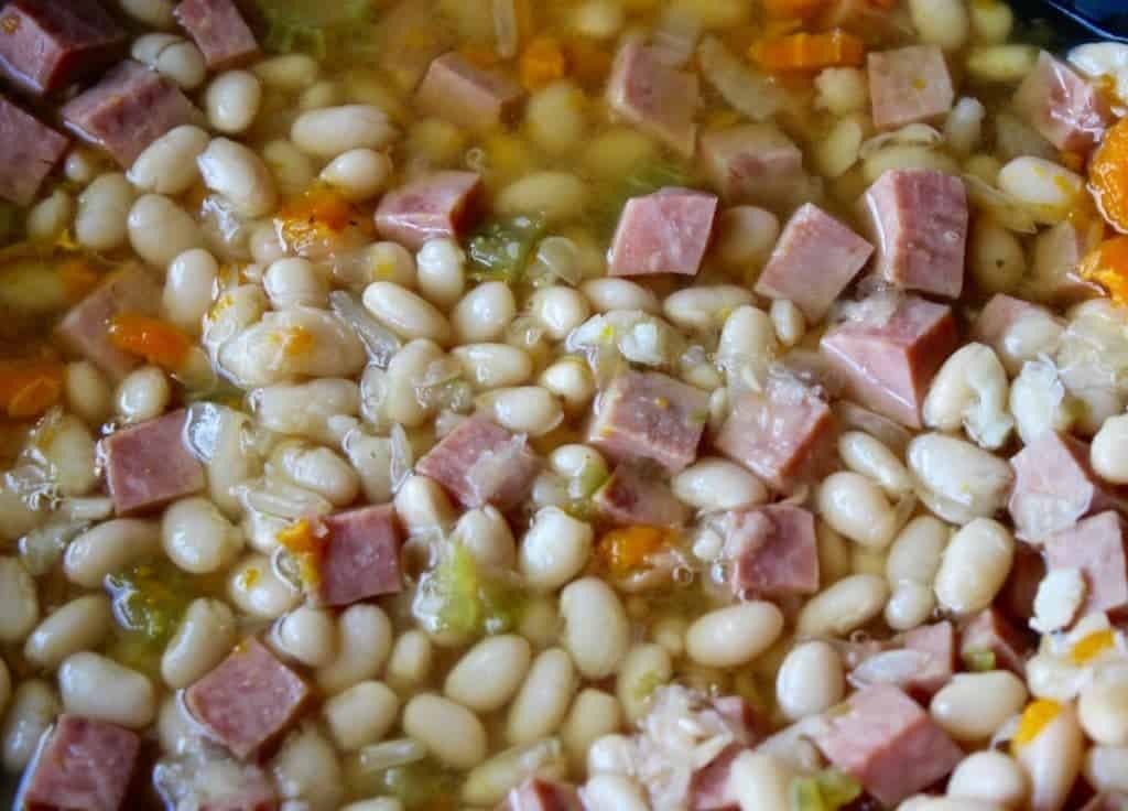 Delicious and filling navy bean and ham soup, this hearty, gluten free, high fiber, dairy free soup is the perfect dinner option for a quick and easy meal. 