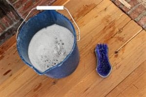 Use a bucket of warm water with a few drops of dish soap (we used Dawn) to properly scrub and clean fireplace 