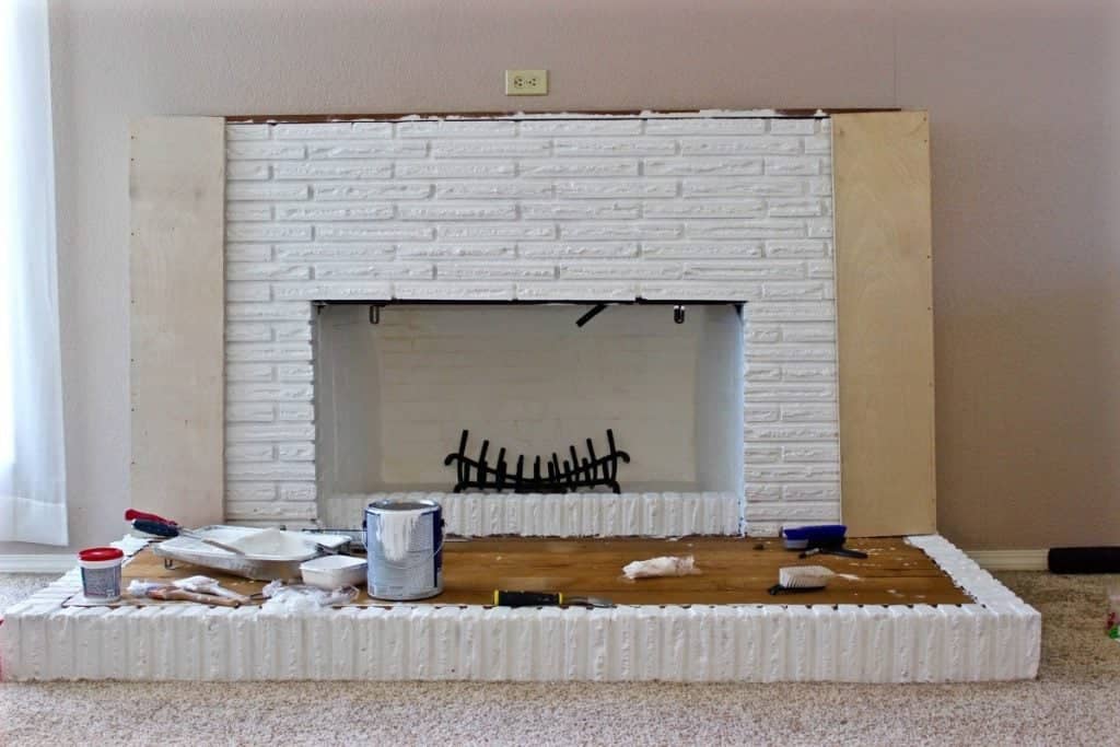 You can see the sides of the mantle that we are now in the process of building! Also that black wood holder was the nasty old one that was rusted in the original fireplace. We took it out and brushed it with a wire brush and sprayed it with Rust - Oleum! love it!