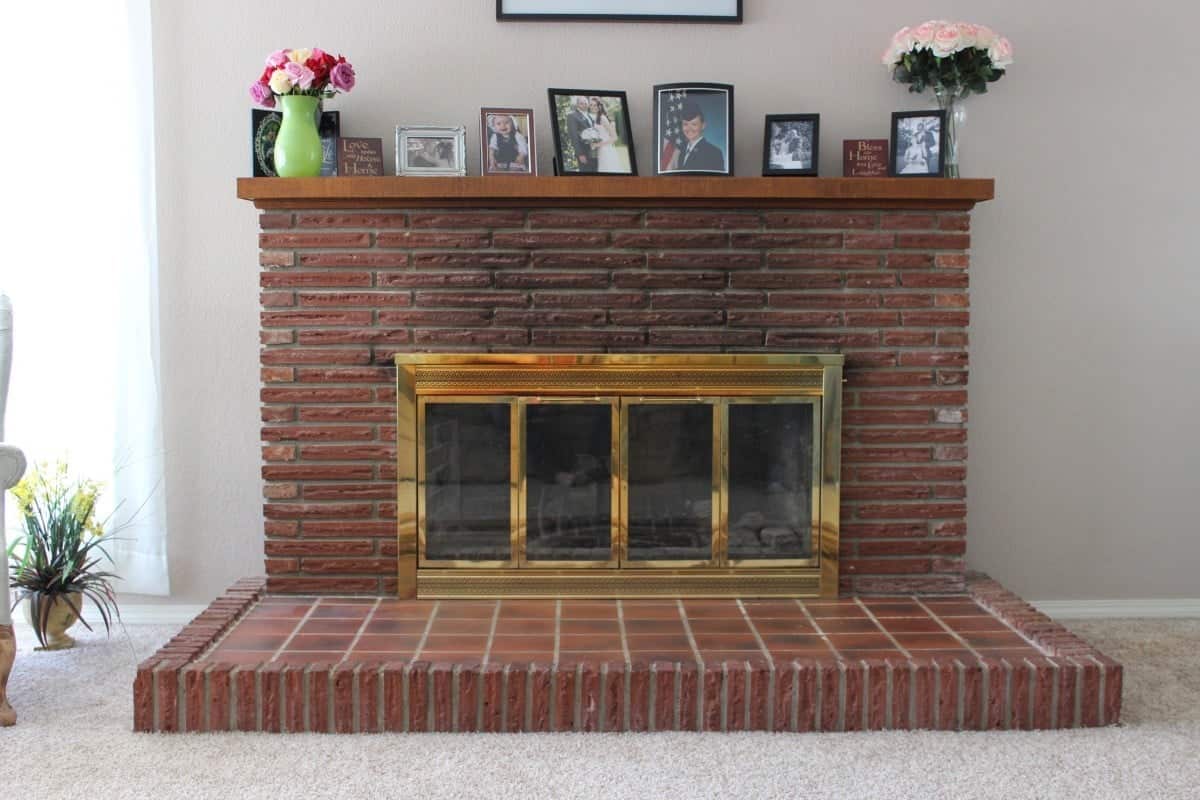 DIY Fireplace Overhaul Reveal See how we transformed our ugly old fireplace into a gorgeous focal point for our home! #DIY #diy #fireplace #brickfireplace #paintingbrickfireplace #fireplaceremodel #fireplaceoverhaul #brick #fireplace #paint