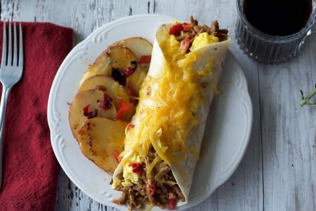 Breakfast Burrito A messy, flavorful, delicious, South of the border, breakfast burrito that satisfies those morning munchies. Stuffed with chorizo sausage, cheddar cheese, peppers and scrambled eggs. This is a filling, low carb, low sugar, handful of nutrition! https://homemadefoodjunkie.1wp.site
