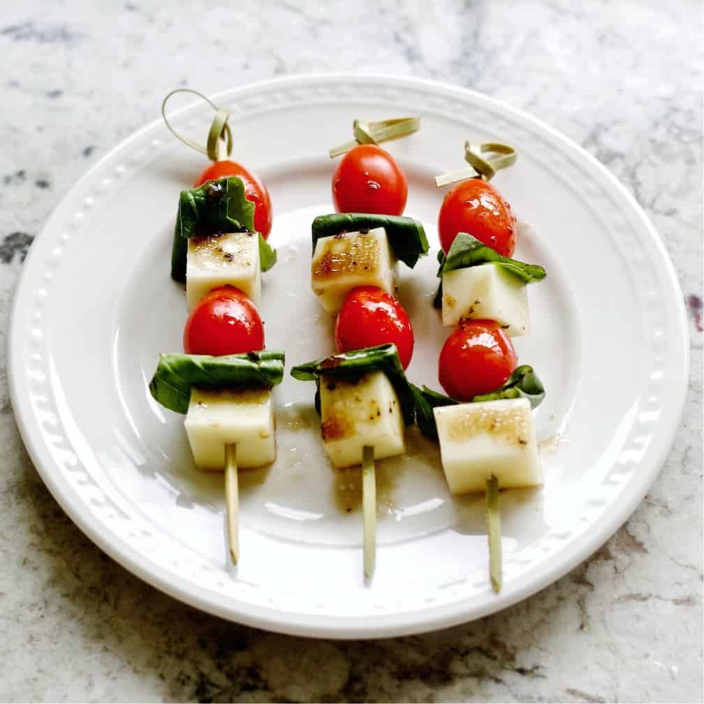 Caprese salad bites on a plate.