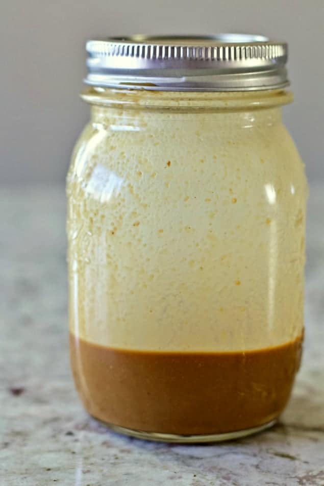 creamy balsamic dressing in a mason jar with a lid.