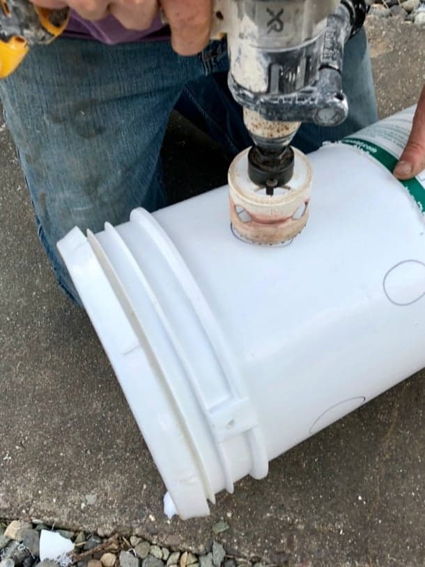 Cutting holes in buckets for DIY strawberry towers