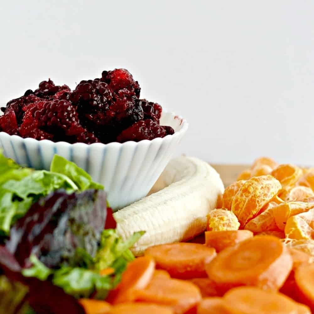 Healthy Blackberry Smoothie ingredients Frozen blackberries with an array of healthy greens and fruits