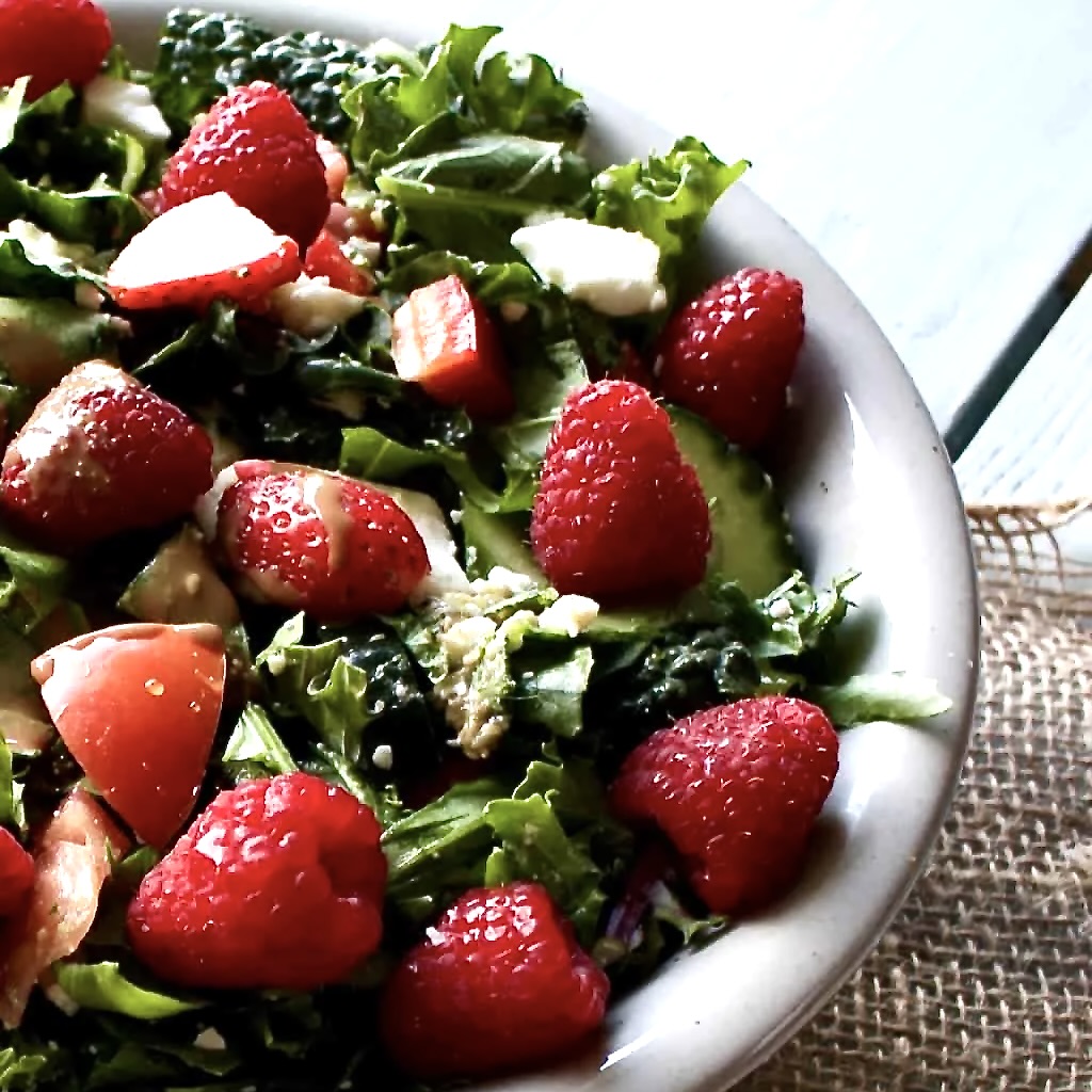 garden berry salad in a grey stoneware bowl on a piece of burlap