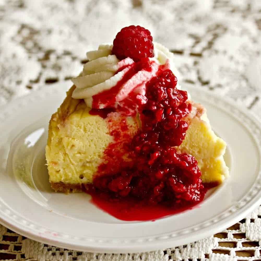Instant Pot White Chocolate Raspberry Swirl Cheesecake with roasted raspberries