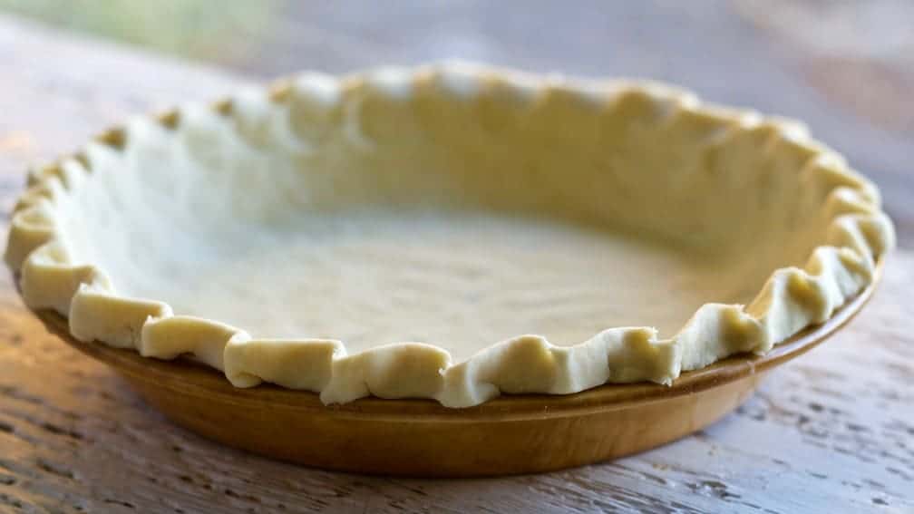 Sourdough Pie Crust in a nine inch brown pie plate. Ready to bake.