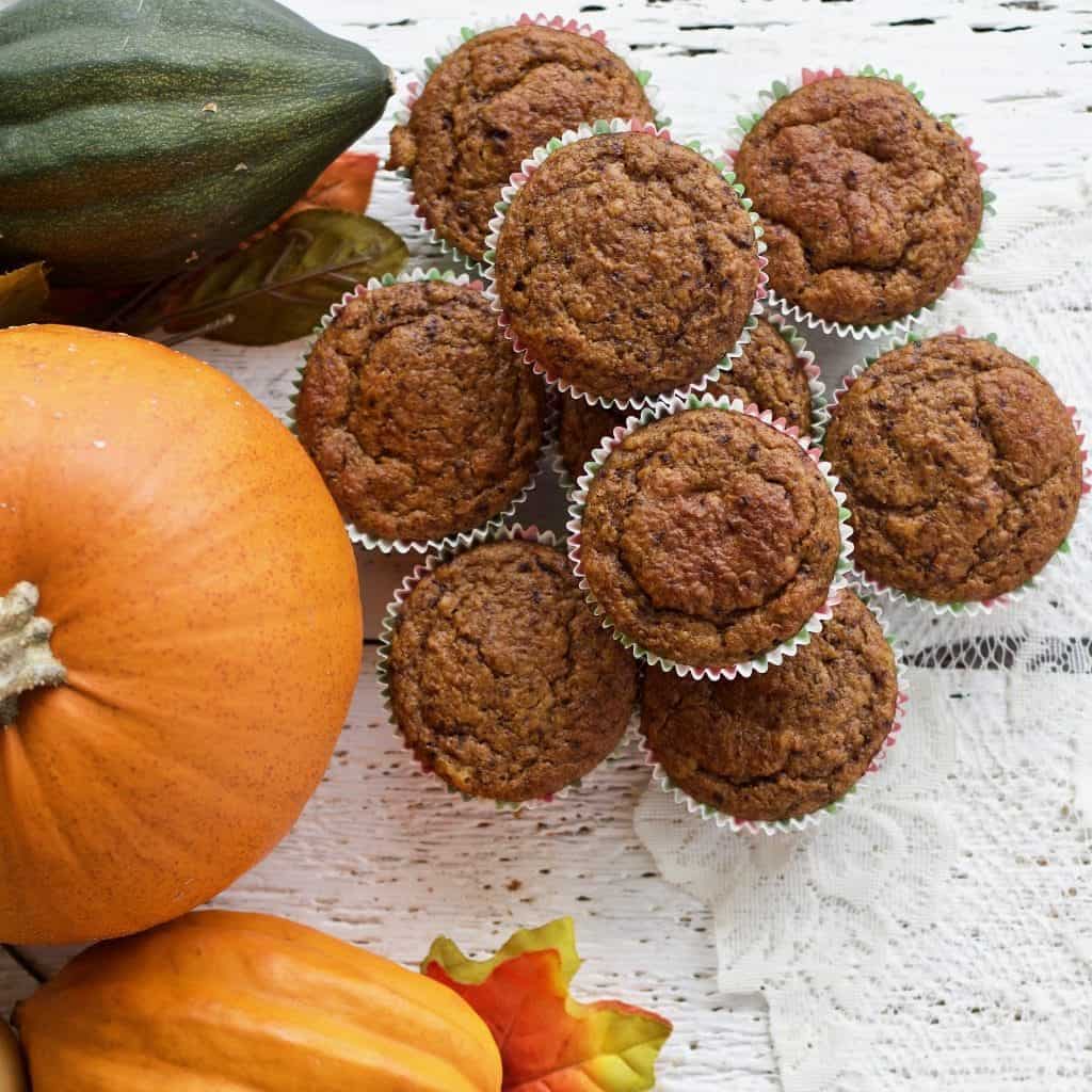 Sourdough pumpkin muffins next to winter squash