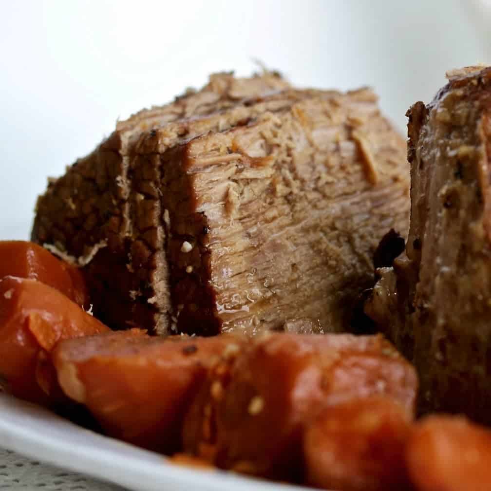 Instant Pot Roast Beef sliced on a platter with vegetables