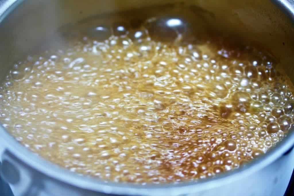 Boiling wine sauce in a pot for Smoky Moose meat Skillet Dinner