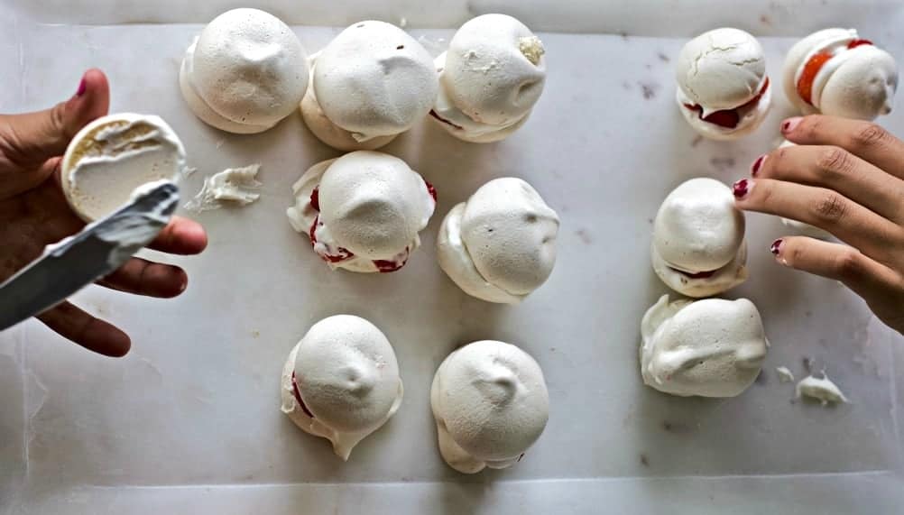 Double Stuffed Berry Meringues are light clouds of baked meringue filled with cream and berries. No cream of tartar needed. Fill the meringues with your favorite berries and cream for a delicious light appetizer or family night dessert. Great dessert for whatever berries are fresh in season. #meringues #dessert #partyfood. Dessertable #freshberries #kidsinthekitchen #kidscooking #summerfun