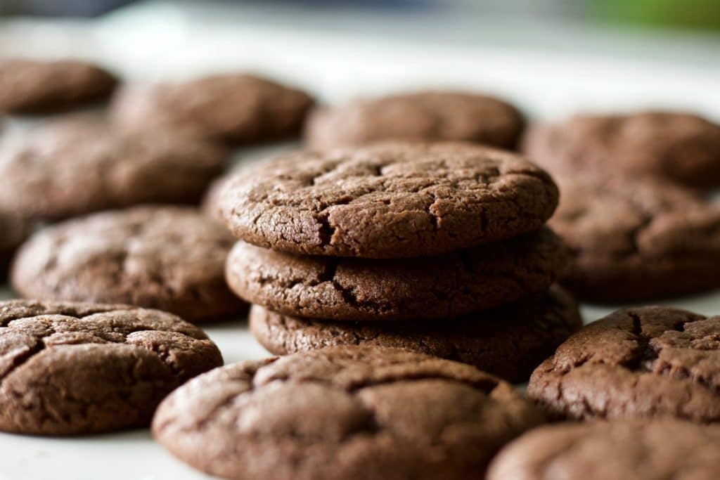 Chewy Chocolate Cookies batch with a stack of cookies in the middle of a cookie pile. 