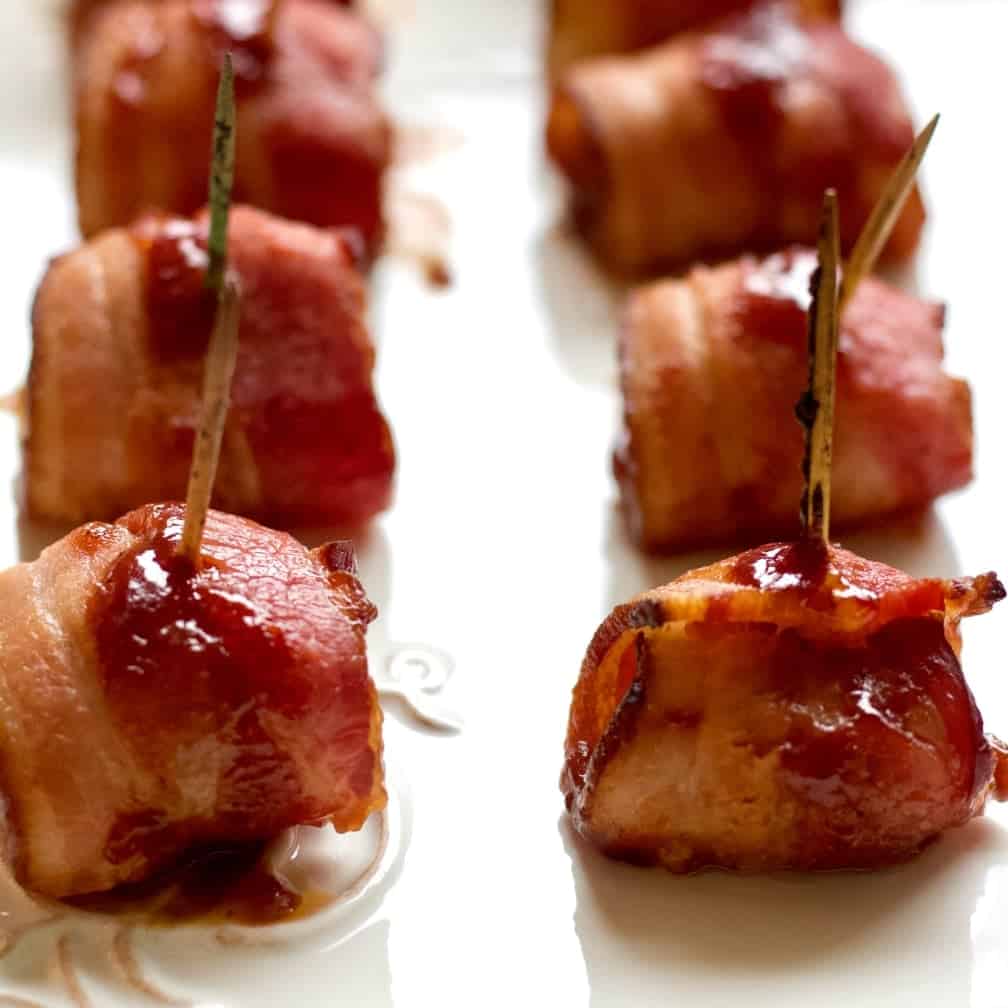 bacon wrapped water chestnuts on a serving tray