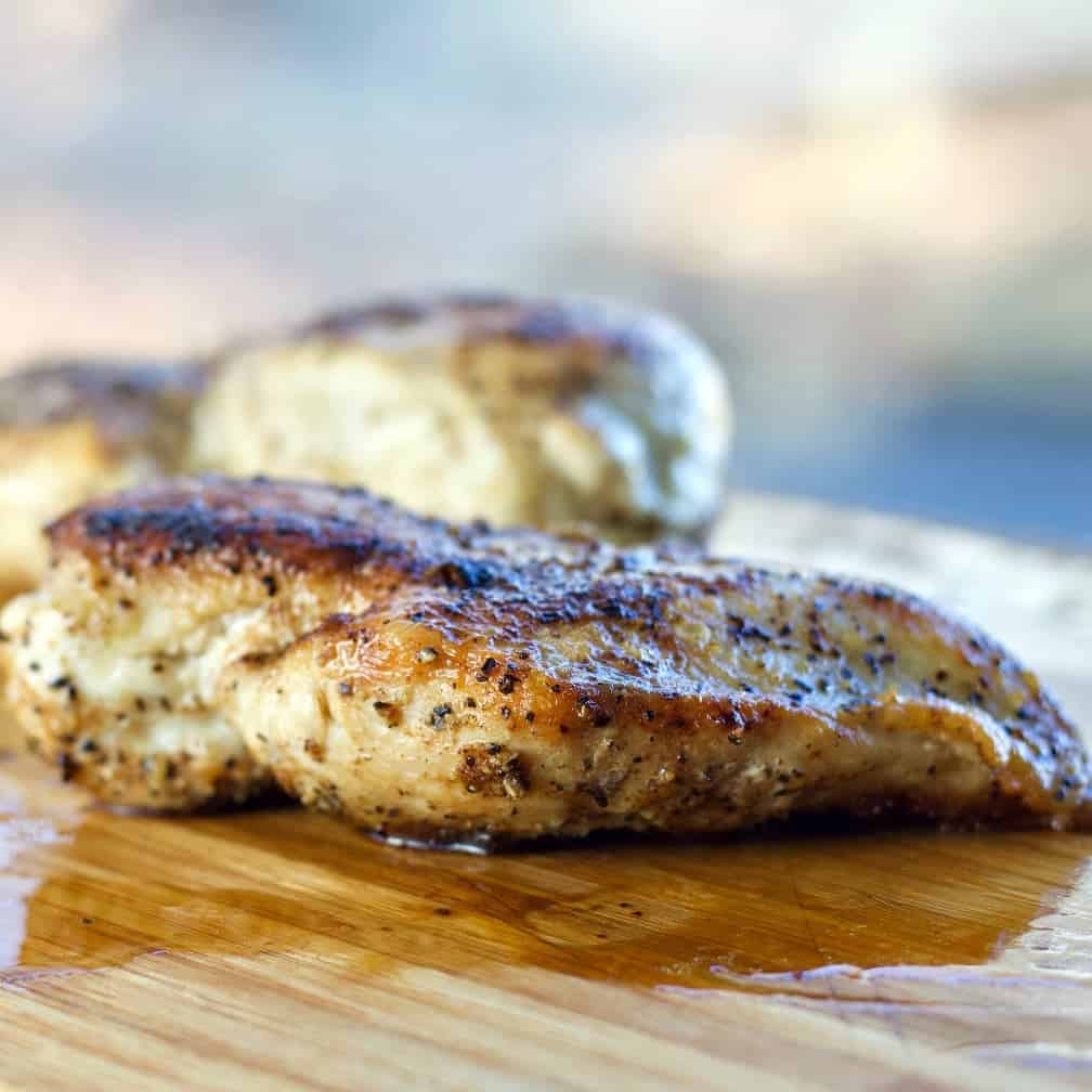 Pan Fried Chicken rested on a cutting board.