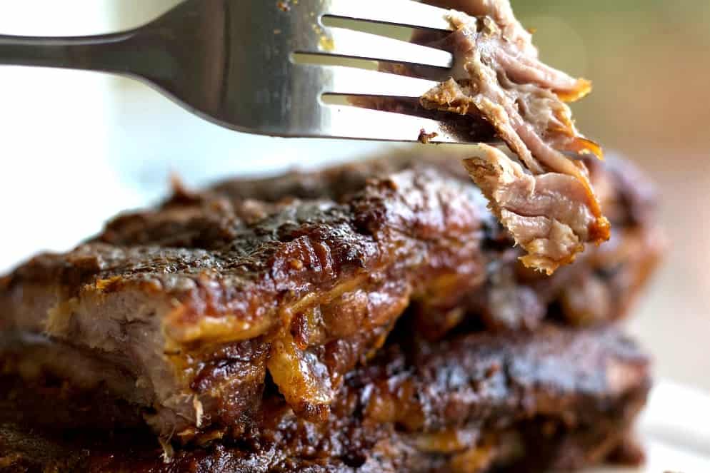 Baby Back Ribs with a forkful of meat up close.