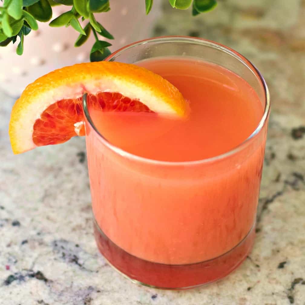 Sex on the beach cocktail garnished with a blood orange