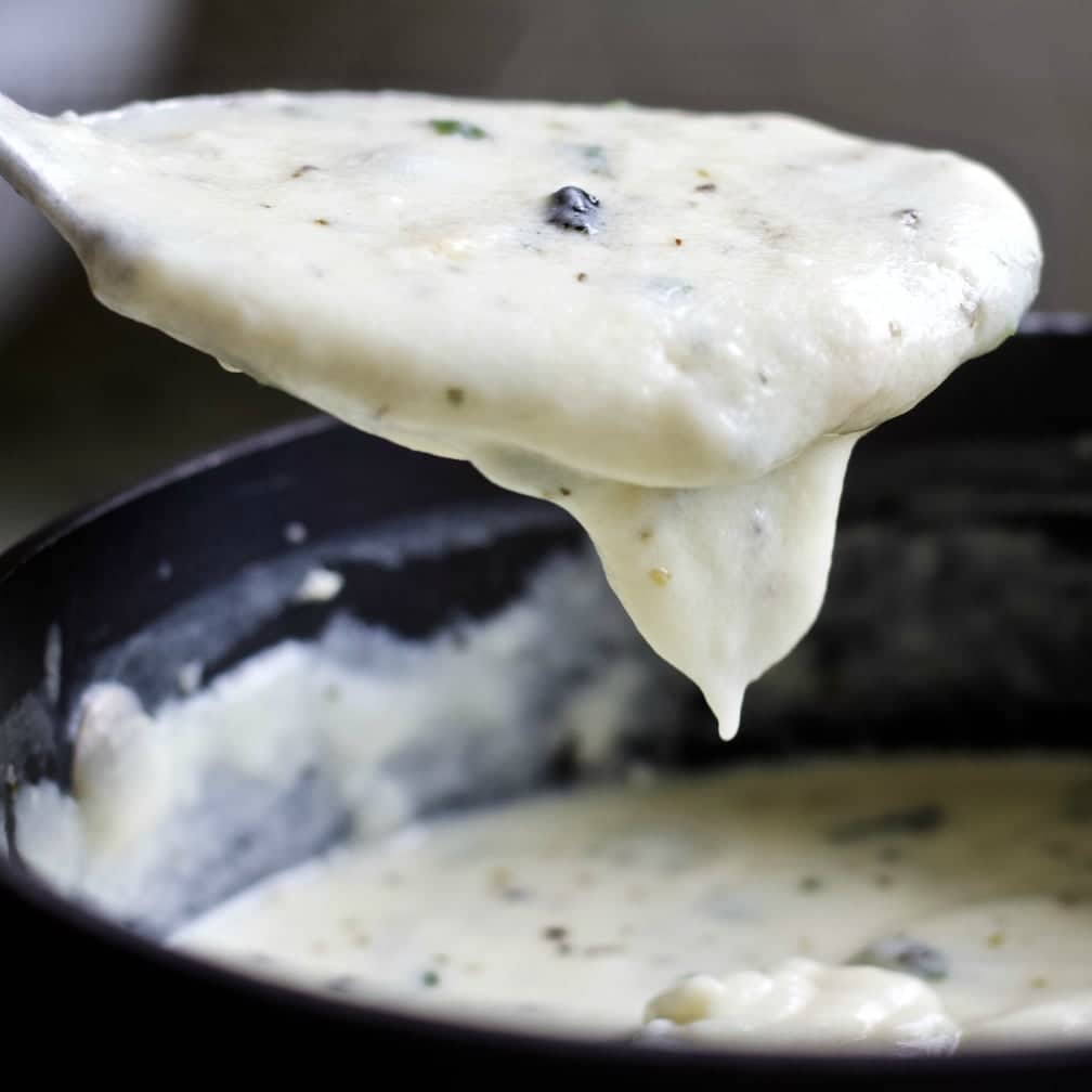 homemade alfredo sauce with Italian herbs, fresh basil and parmesan cheese