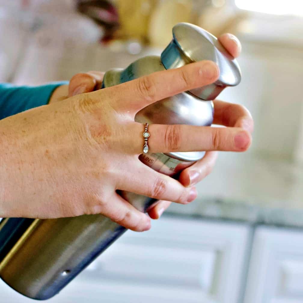 holding a cocktail shaker