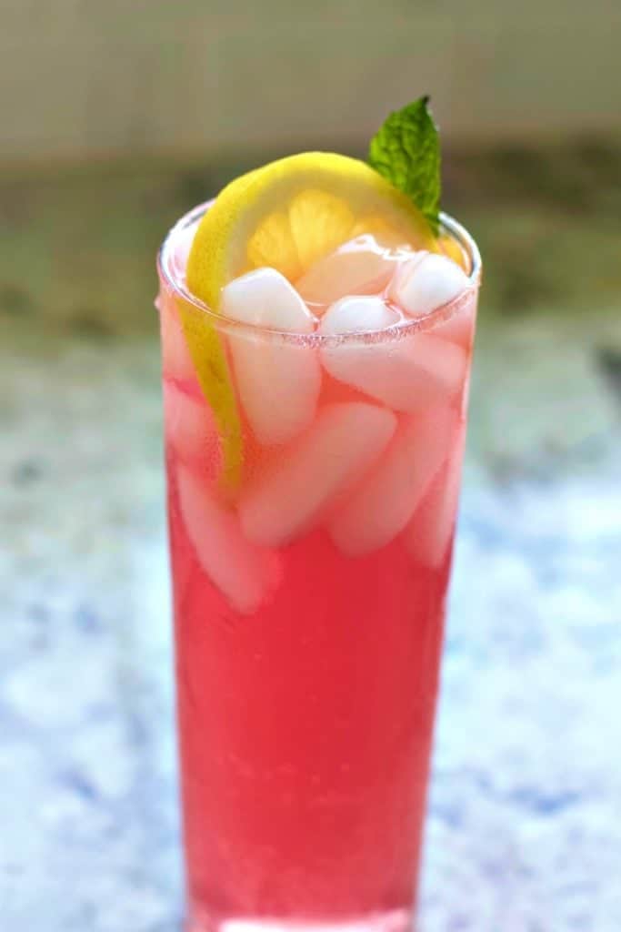 Pink Lemonade vodka drink garnished with a lemon wheel and mint leaf