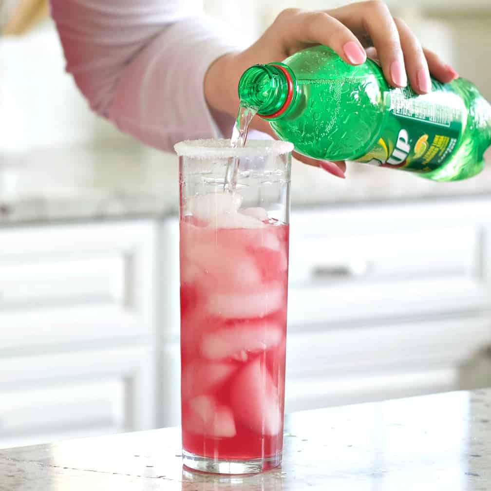 Pouring 7 up to top off the glass