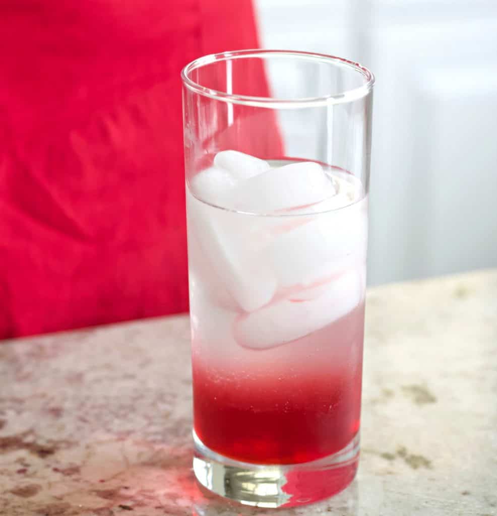 red white and blue vodka drink with the grenadine layer and vodka/lemonade layer complete.