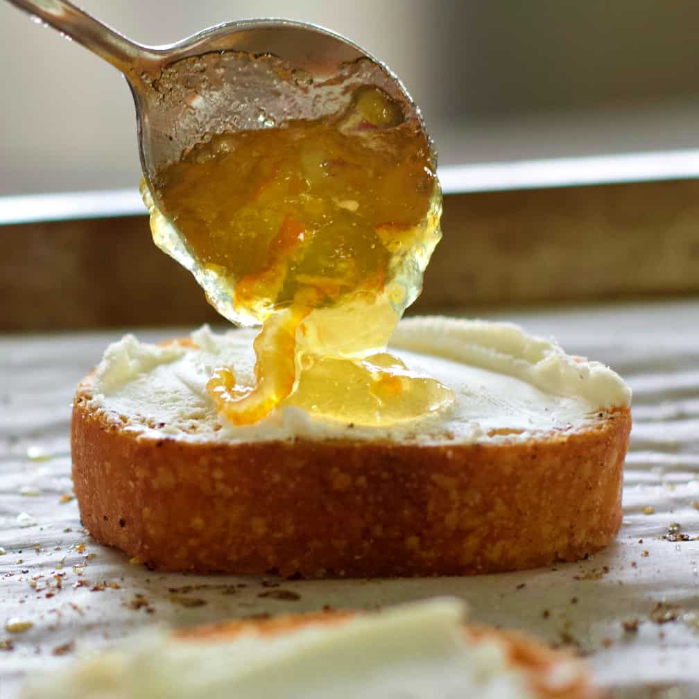 Goat Cheese Crostini Appetizer with Marmalade and Pecan 12 Spoon on the marmalade