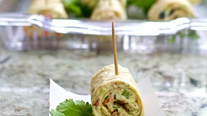single cream cheese bite with loaded tray behind