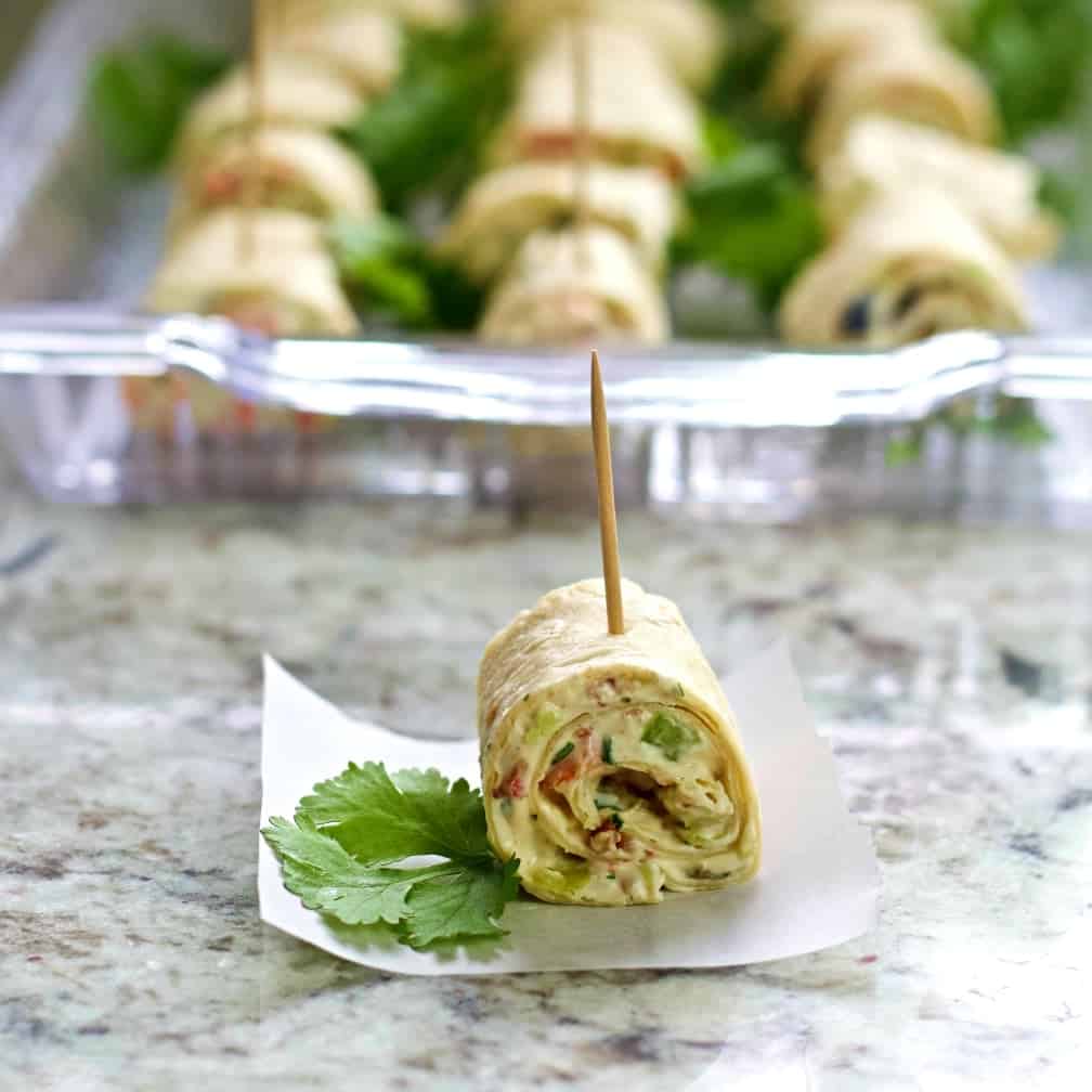 single cream cheese bite with loaded tray behind
