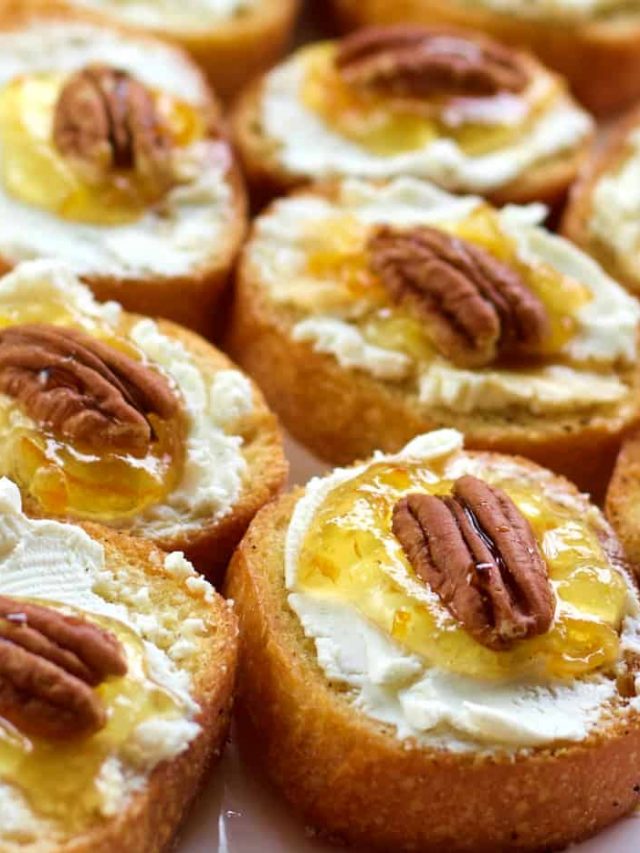 several crostini with goat cheese on a plate
