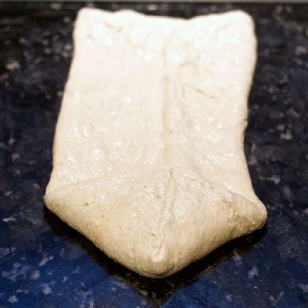 Soft Sourdough Sandwich Bread Recipe 25 fold front points-forming dough for bread pan.