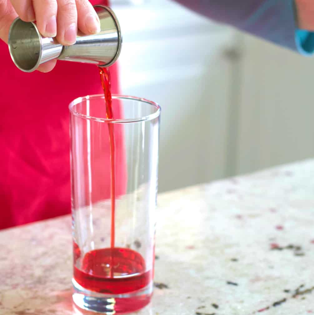 pouring the bottom grenadine layer.