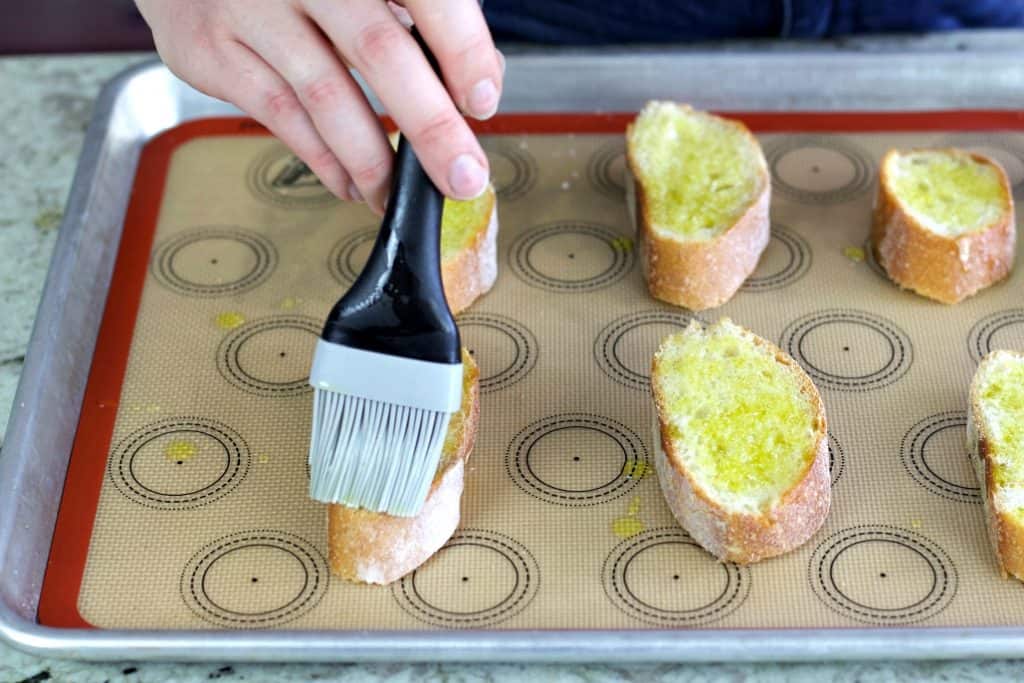 Brushing oil on bruschetta
