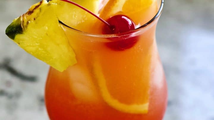Mai Tai in the fruity mixed drink form. Garnished with a pineapple wedge. half orange slice and maraschino cherry