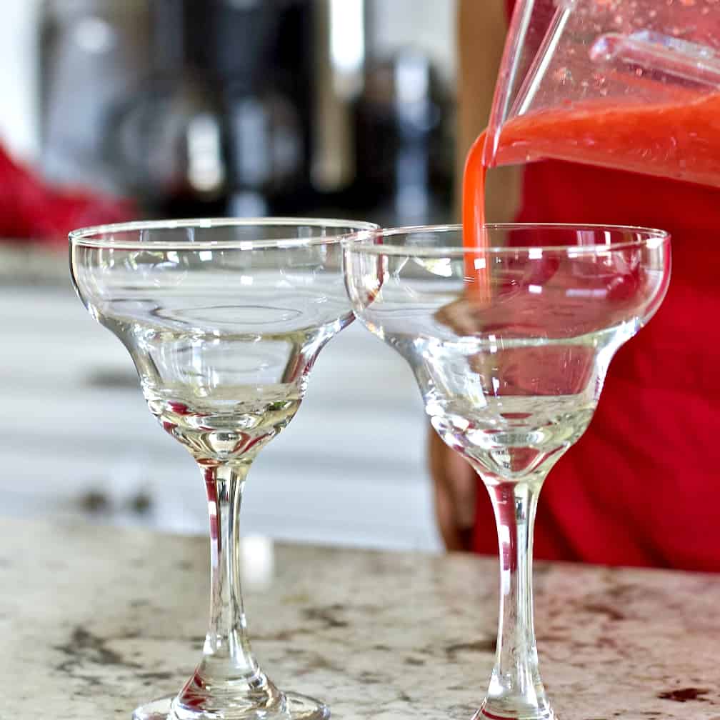 Strawberry Daiquiri Recipe with Malibu Coconut Rum 5 Pouring a strawberry daiquiri into a Margarita glass.